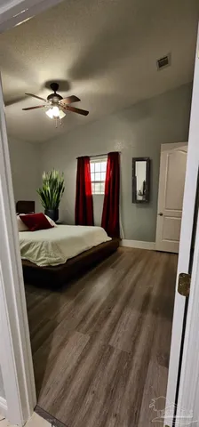 a view of a house with backyard and a tree