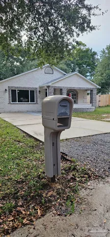 a view of a house with a yard and hanging chair
