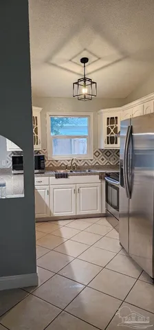 a kitchen with stainless steel appliances granite countertop a refrigerator and stove