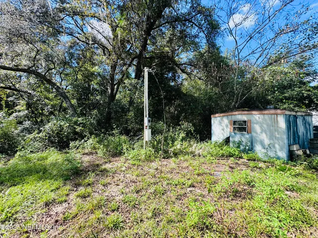 a backyard of a house with lots of green space