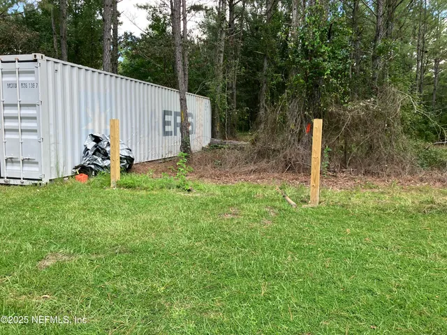 a view of backyard with small cabin and entertaining space