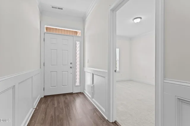 a view of a hallway with wooden floor