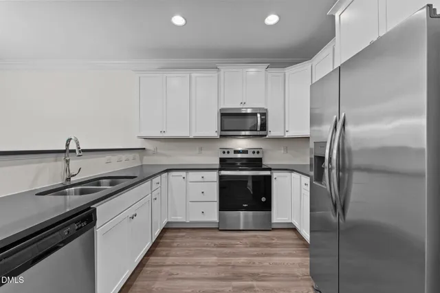 a kitchen with a sink stainless steel appliances and cabinets
