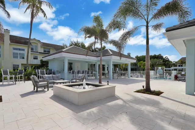 a view of a patio with swimming pool table and chairs