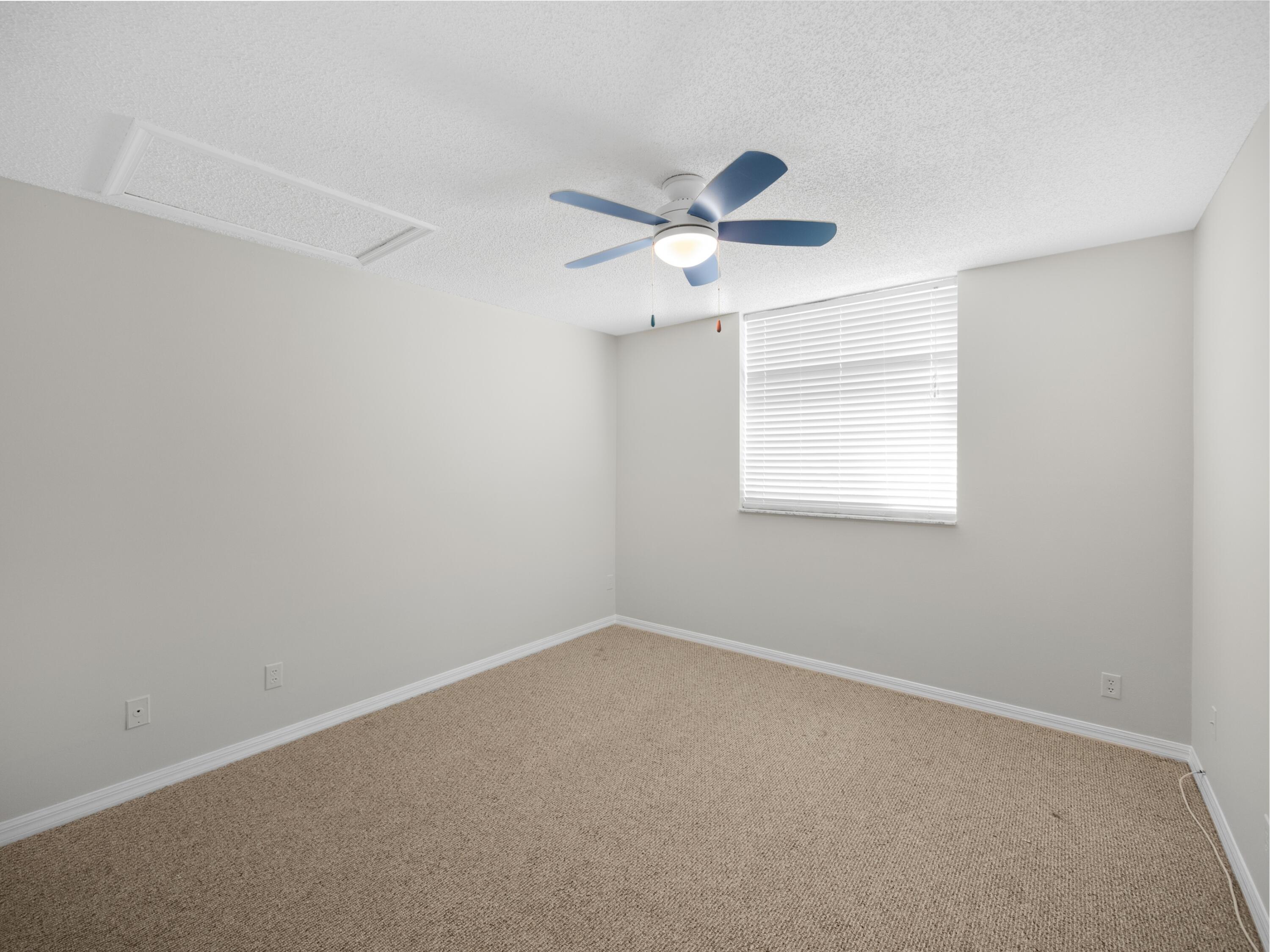 501 Mainsail Circle Jupiter, FL 33477 - Photo 10 of 29 an empty room with a window and a fan