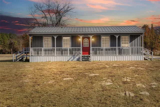 a view of a house with wooden fence