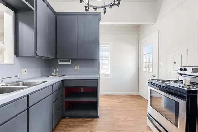 a kitchen with a sink stove and cabinets