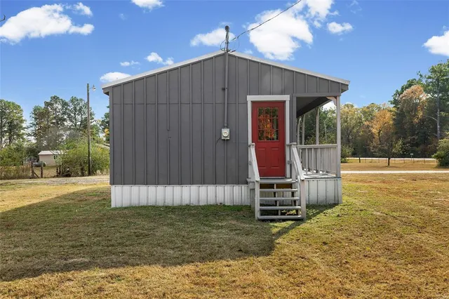 a backyard of a house with toys and wooden fence