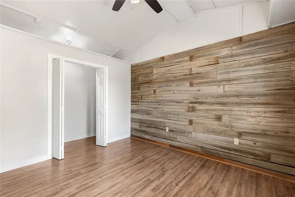 a view of an empty room and wooden floor
