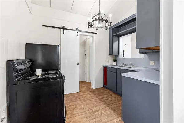 a kitchen with a sink stove and refrigerator