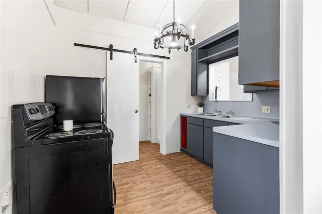 a kitchen with a sink stove and refrigerator