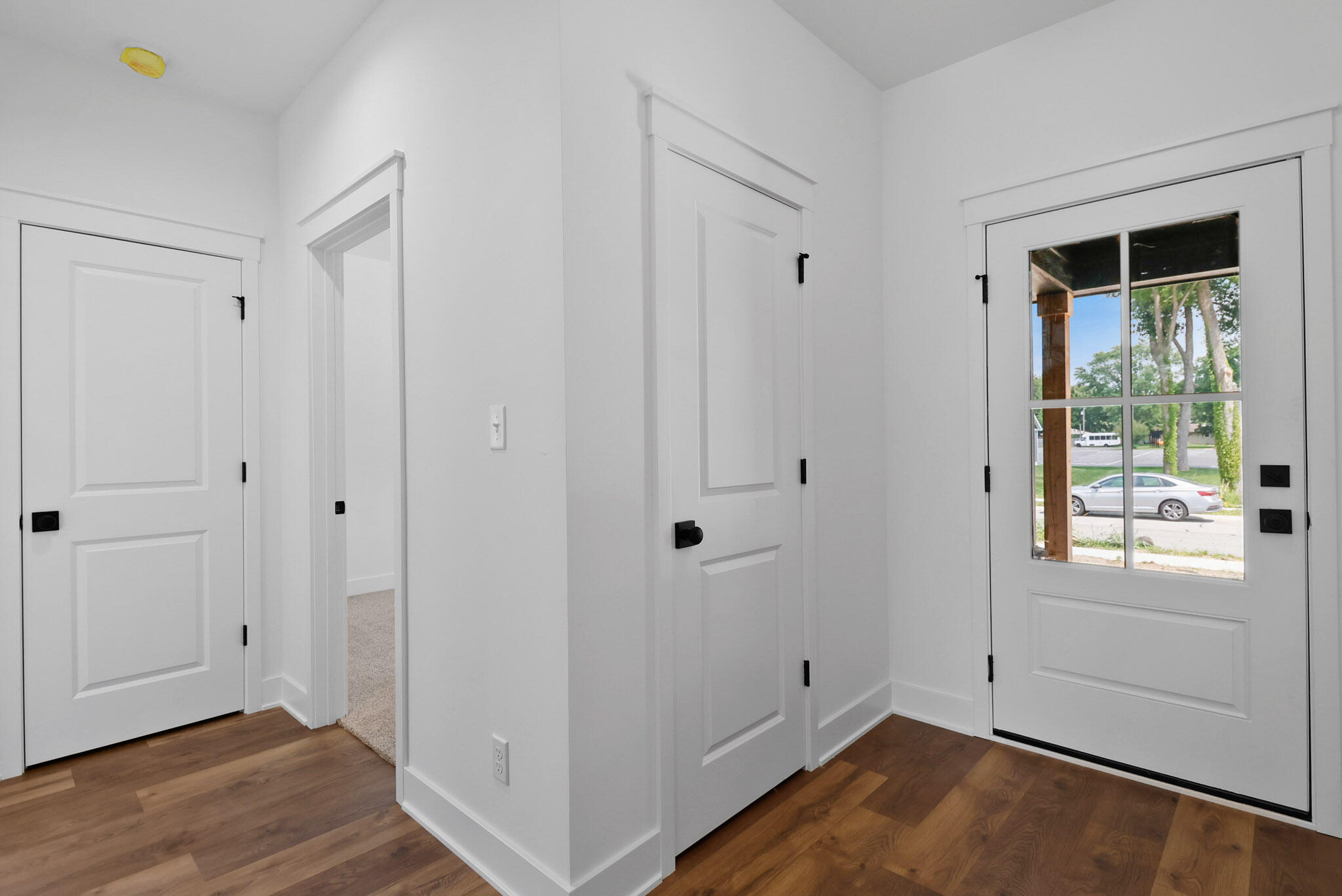 2183 Foley Street Portage, IN 46368 - Photo 3 of 22 a view of an empty room with wooden floor and a window