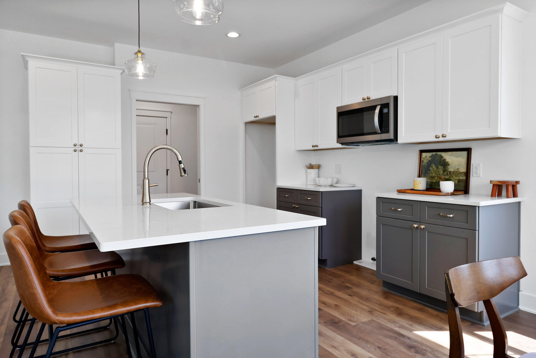 2183 Foley Street Portage, IN 46368 - Photo 10 of 22 a kitchen with stainless steel appliances a sink a stove a refrigerator cabinets and dining table with wooden floor