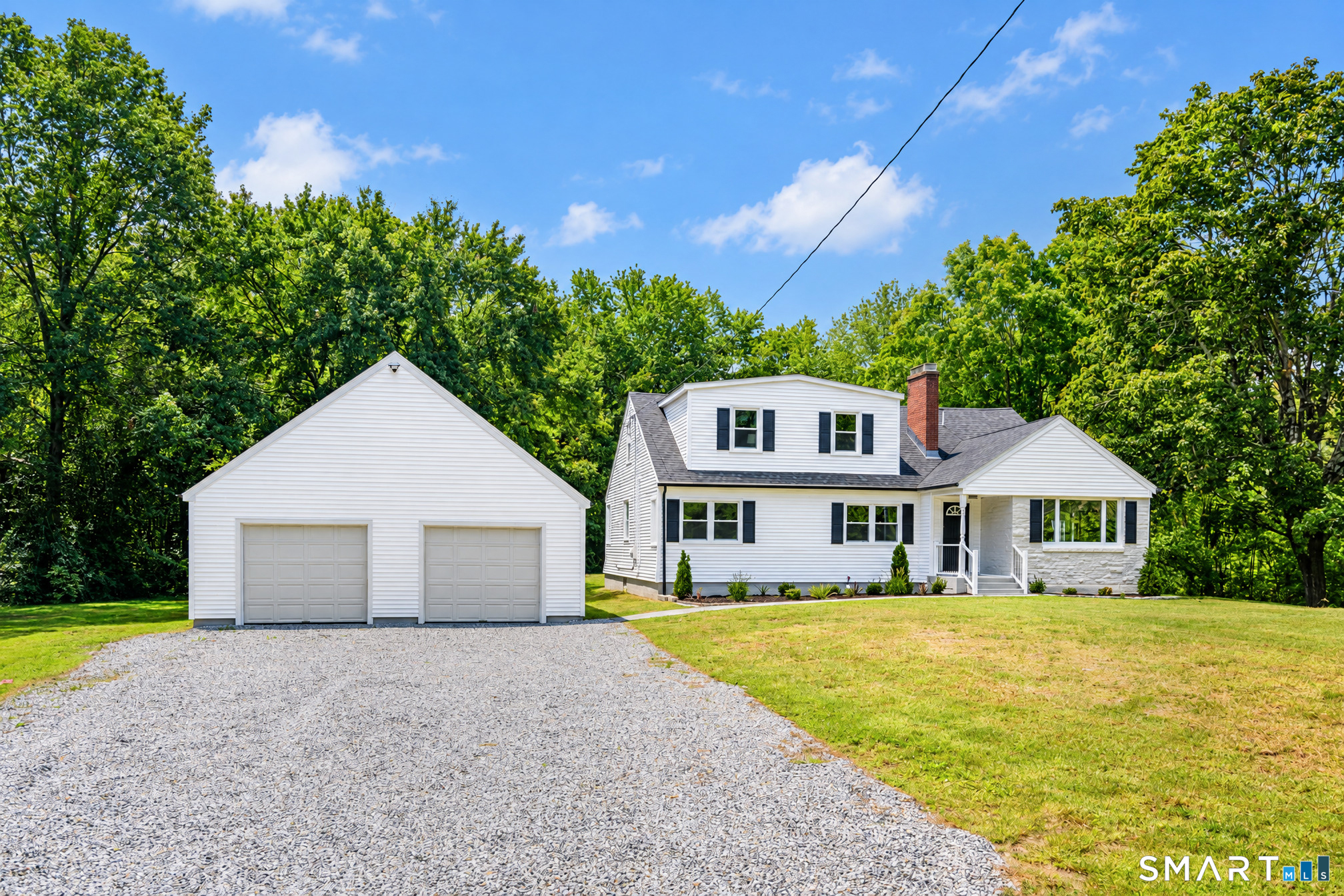 34 Rimmon Road Woodbridge, CT 06525 - Photo 1 of 40 Welcoming exterior with detached two-car garage and expansive driveway.