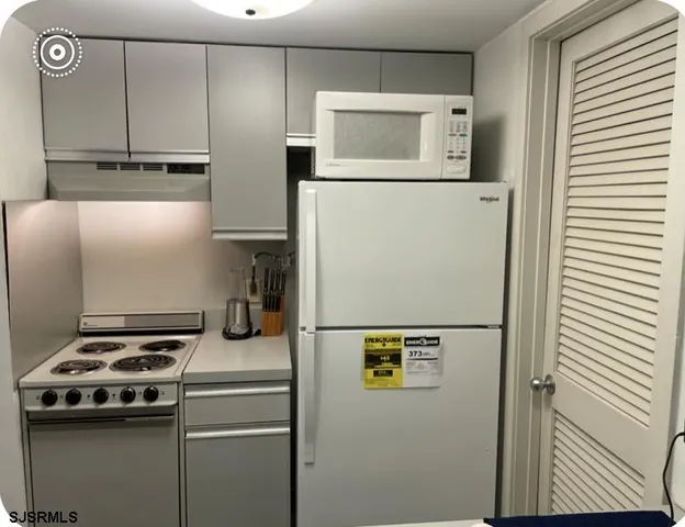 a kitchen with a refrigerator and a stove