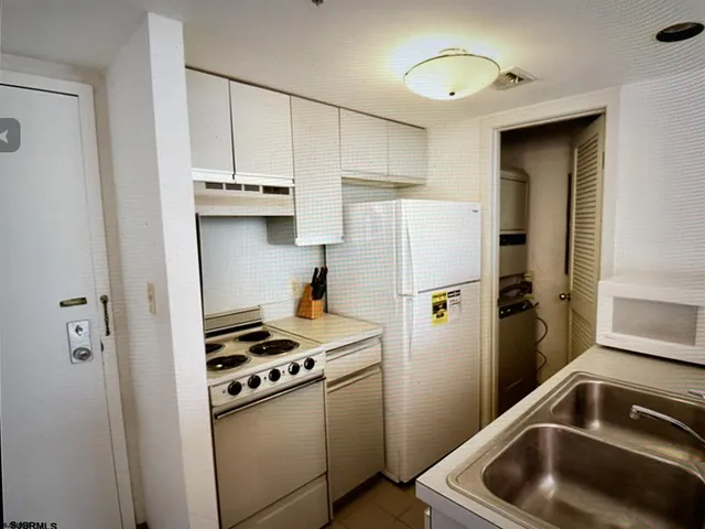 a kitchen with a refrigerator and a sink