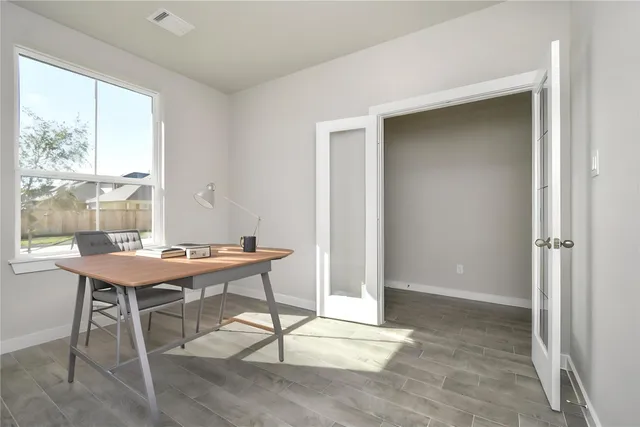 a large kitchen with kitchen island a stove a sink a center island and wooden floor