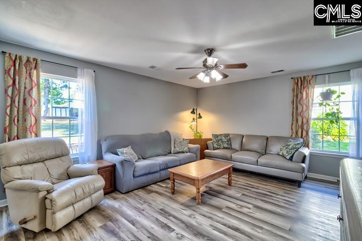 209 Eagle Pointe Drive Chapin, SC 29036 - Photo 16 of 40 a living room with furniture a chandelier and a window