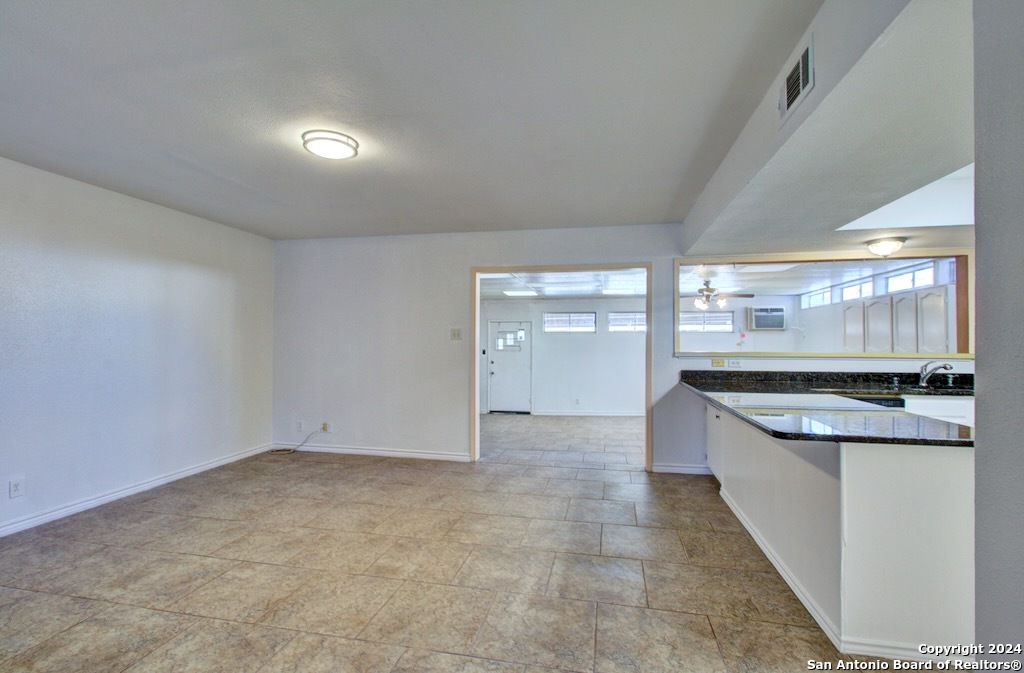 6810 Crown Ridge San Antonio, TX 78239 - Photo 15 of 34 an empty room with kitchen view and a window