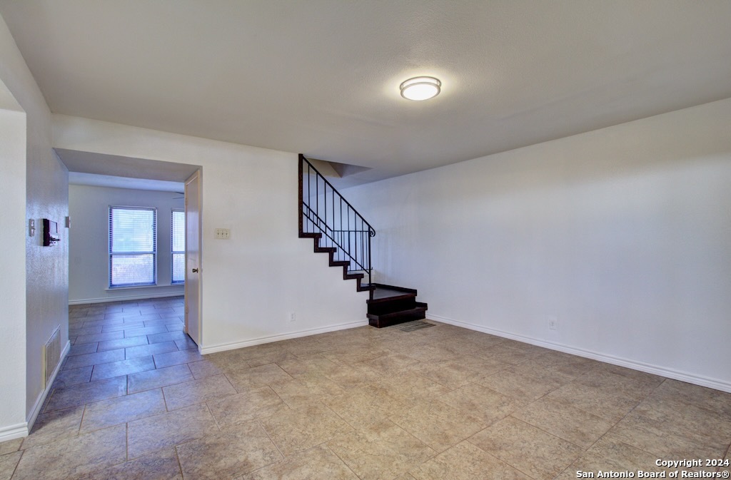 6810 Crown Ridge San Antonio, TX 78239 - Photo 16 of 34 a view of an empty room with stairs and a window