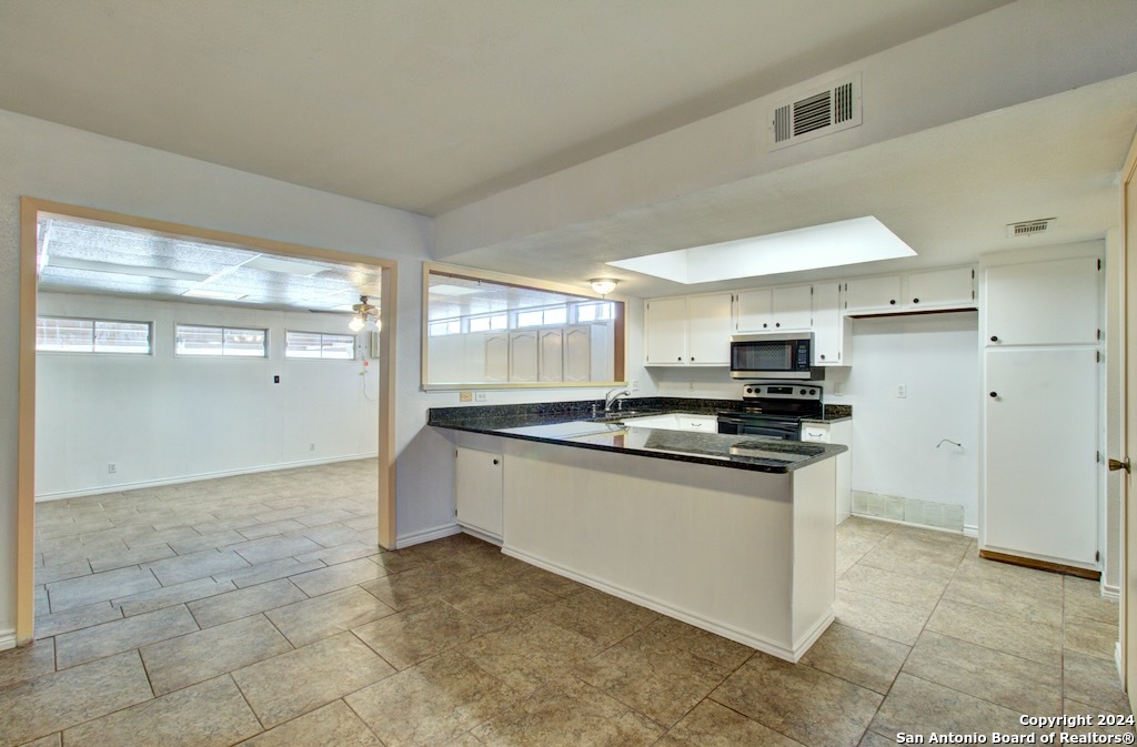6810 Crown Ridge San Antonio, TX 78239 - Photo 18 of 34 a large kitchen with stainless steel appliances granite countertop a sink and cabinets