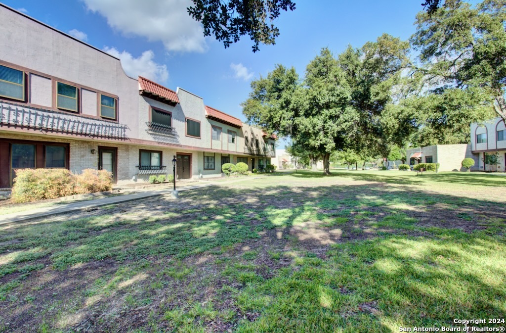6810 Crown Ridge San Antonio, TX 78239 - Photo 2 of 34 a front view of a house with a yard