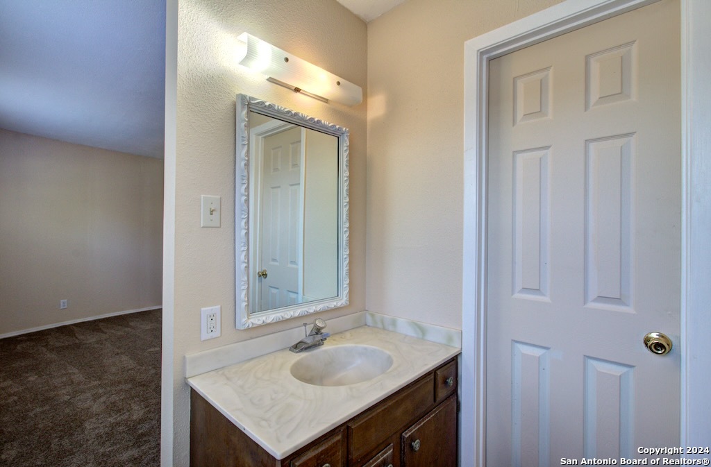 6810 Crown Ridge San Antonio, TX 78239 - Photo 27 of 34 a bathroom with a sink vanity and a mirror