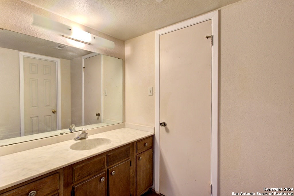 6810 Crown Ridge San Antonio, TX 78239 - Photo 28 of 34 a bathroom with a double vanity sink and a mirror
