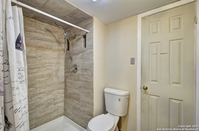 a bathroom with a toilet and shower