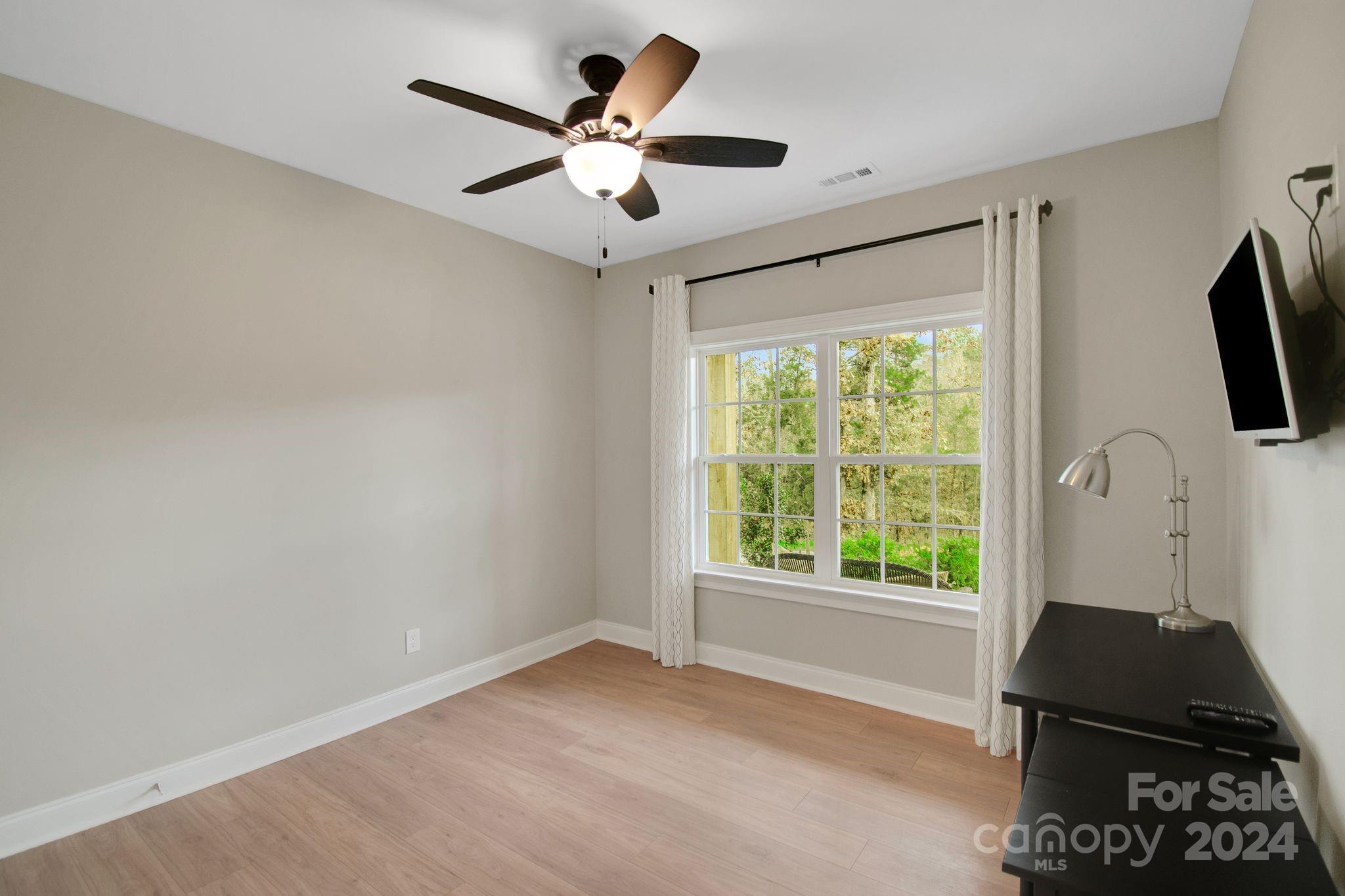 2795 Craig Farm Road Lancaster, SC 29720 - Photo 24 of 44 a view of a livingroom with a flat screen tv and a large window