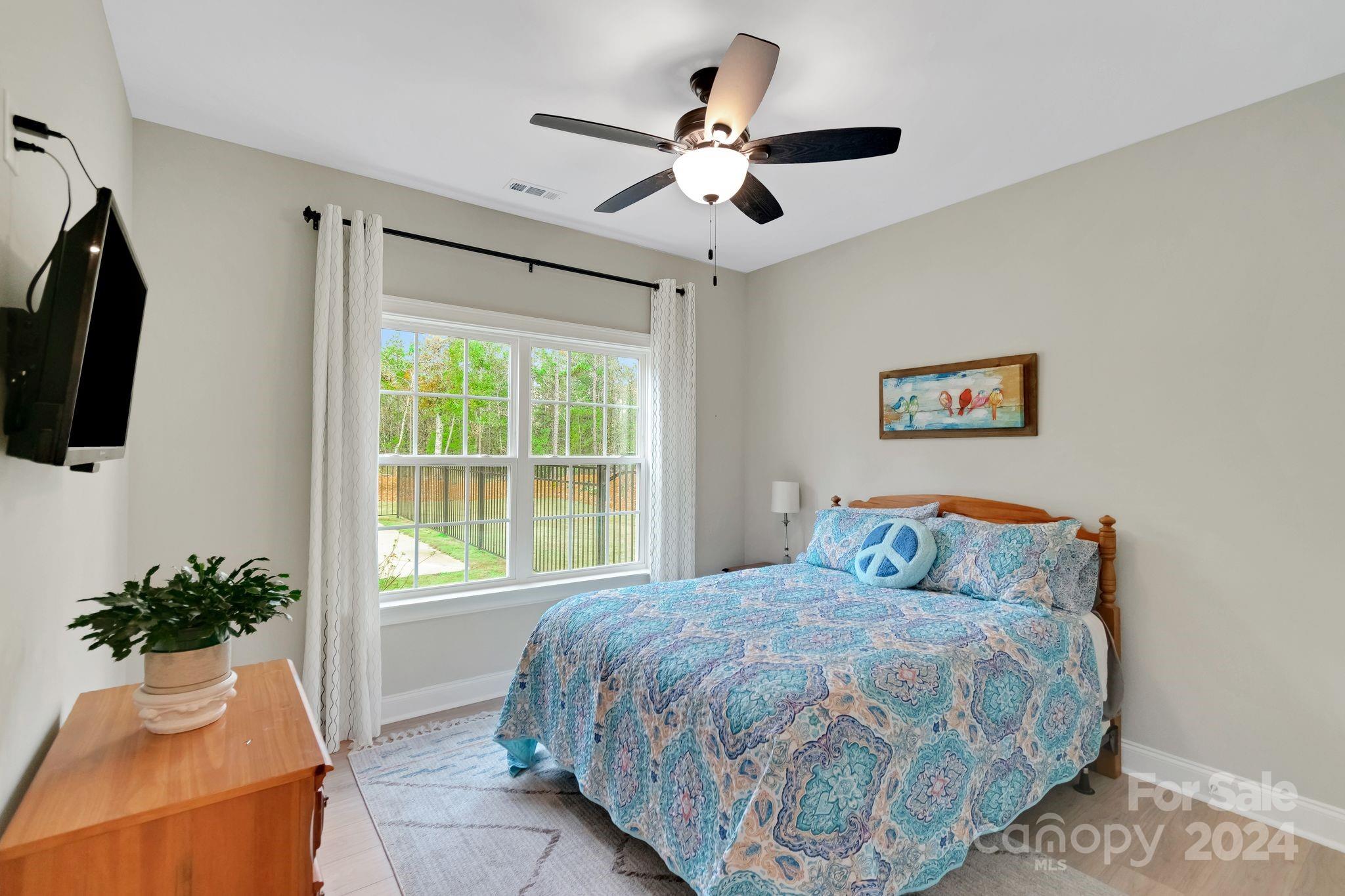 2795 Craig Farm Road Lancaster, SC 29720 - Photo 25 of 44 a bedroom with a large bed and a large window