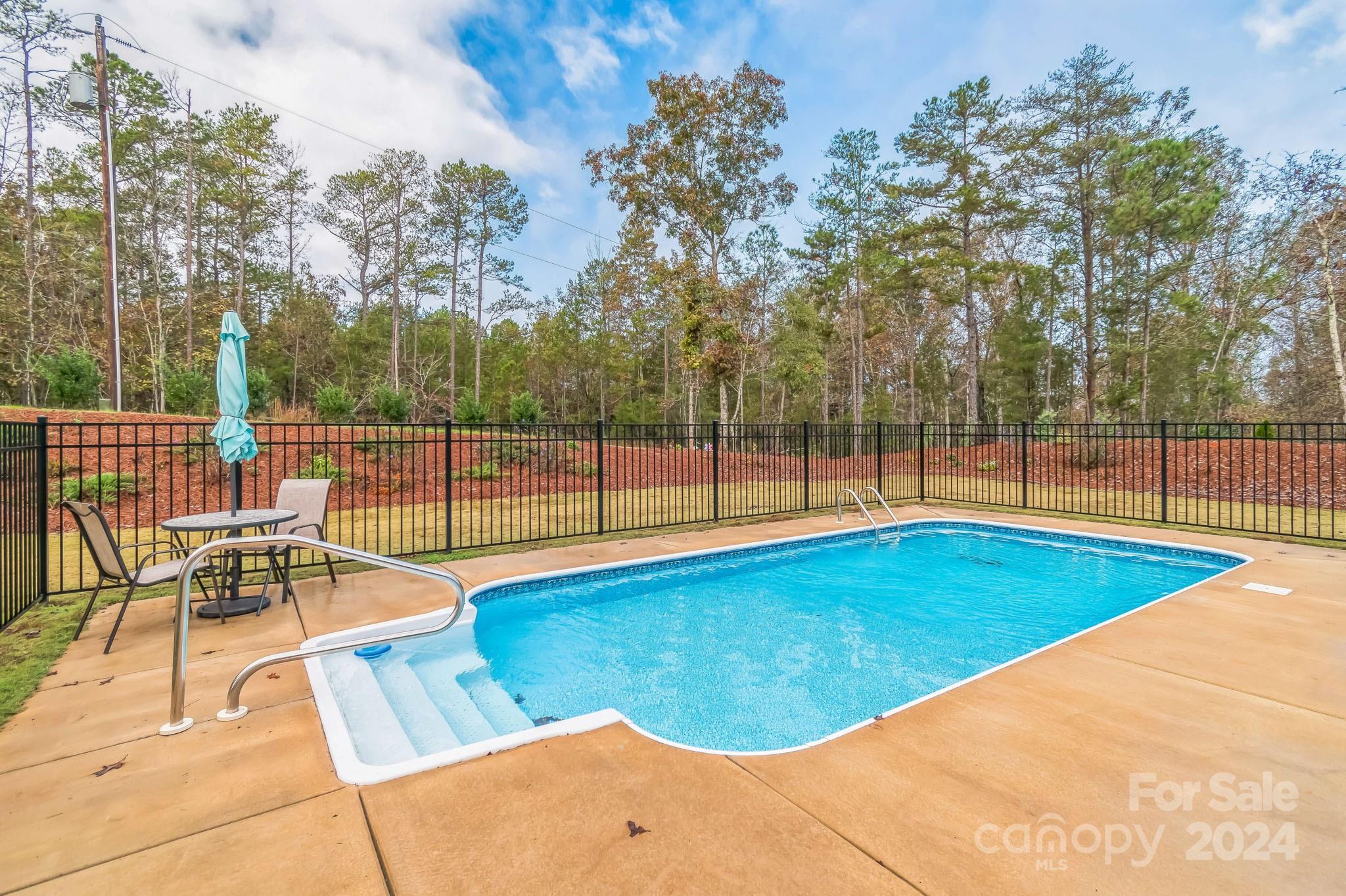 2795 Craig Farm Road Lancaster, SC 29720 - Photo 35 of 44 a view of a swimming pool with a lounge chair
