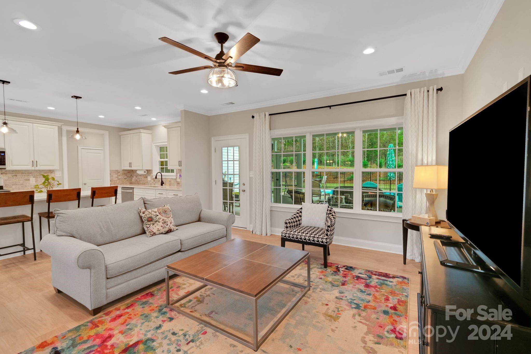 2795 Craig Farm Road Lancaster, SC 29720 - Photo 10 of 44 a living room with furniture a ceiling fan and a flat screen tv