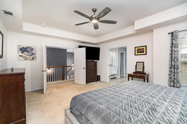 a bedroom with a large bed and a chandelier