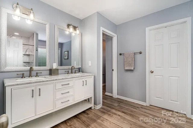 a bathroom with a double vanity sink and mirror