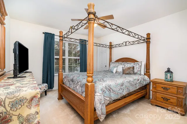 a bedroom with a bed and large mirror