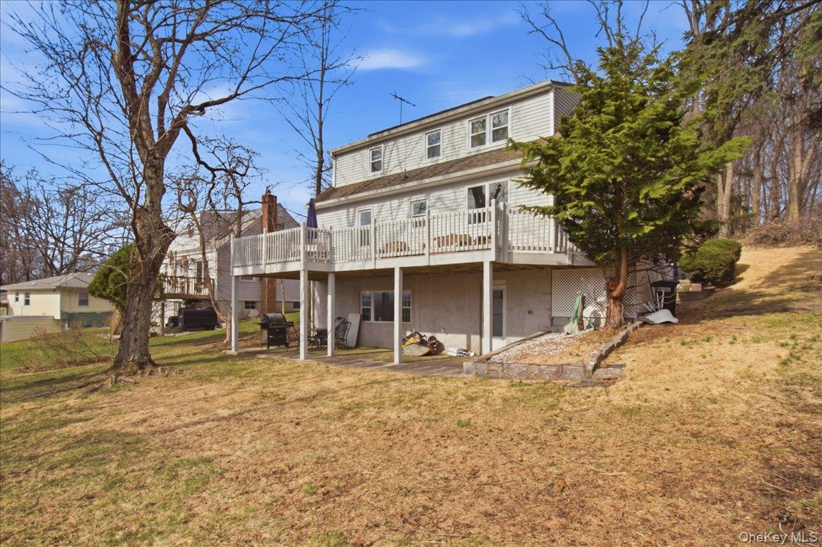 169 Canterbury Road White Plains, NY 10607 - Photo 22 of 27 a view of a house with a large tree and wooden fence