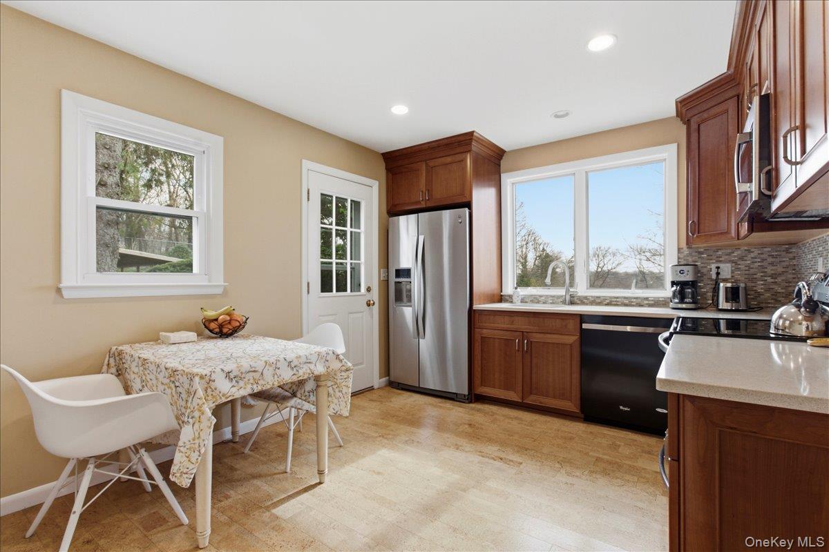169 Canterbury Road White Plains, NY 10607 - Photo 8 of 27 a kitchen with a table chairs refrigerator and cabinets