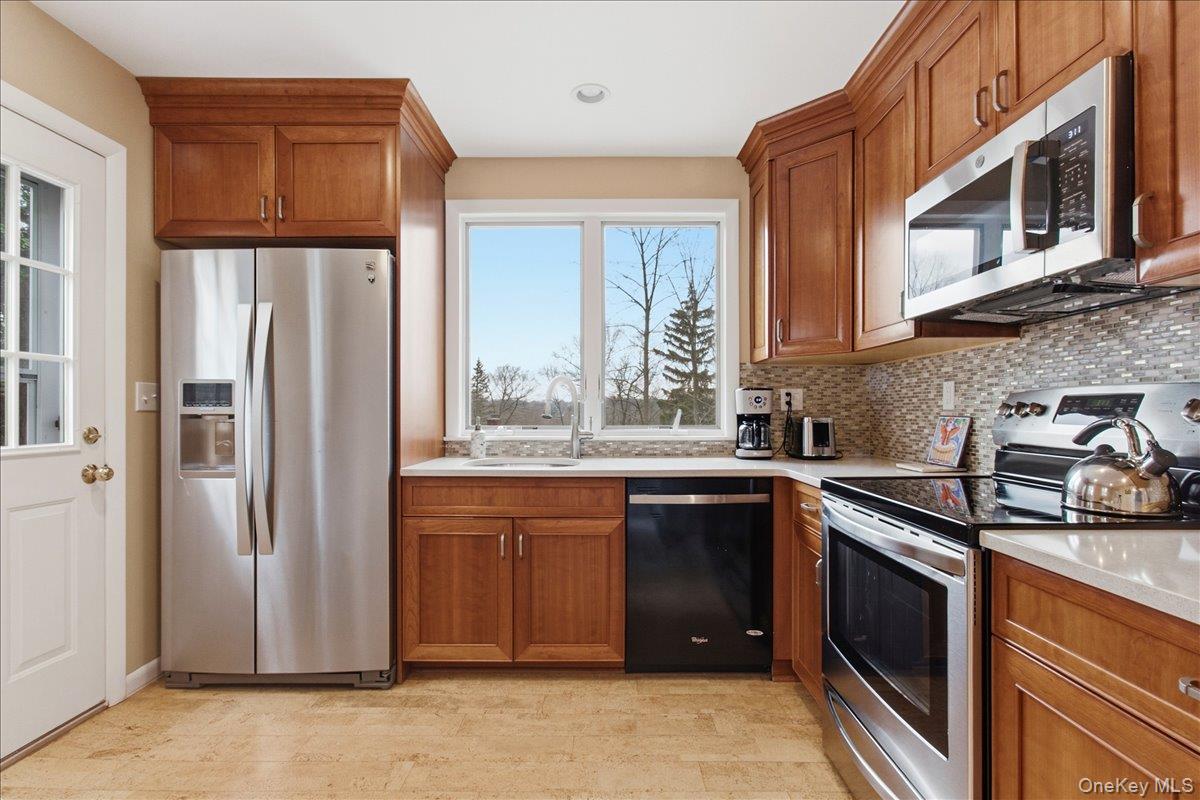 169 Canterbury Road White Plains, NY 10607 - Photo 9 of 27 a kitchen with stainless steel appliances granite countertop a refrigerator and a sink