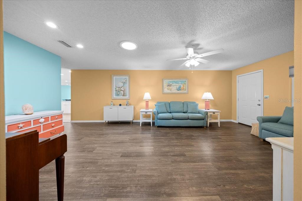 8720 Southwest 90th Street, Unit A Ocala, FL 34481 - Photo 13 of 71 a living room with furniture and a chandelier