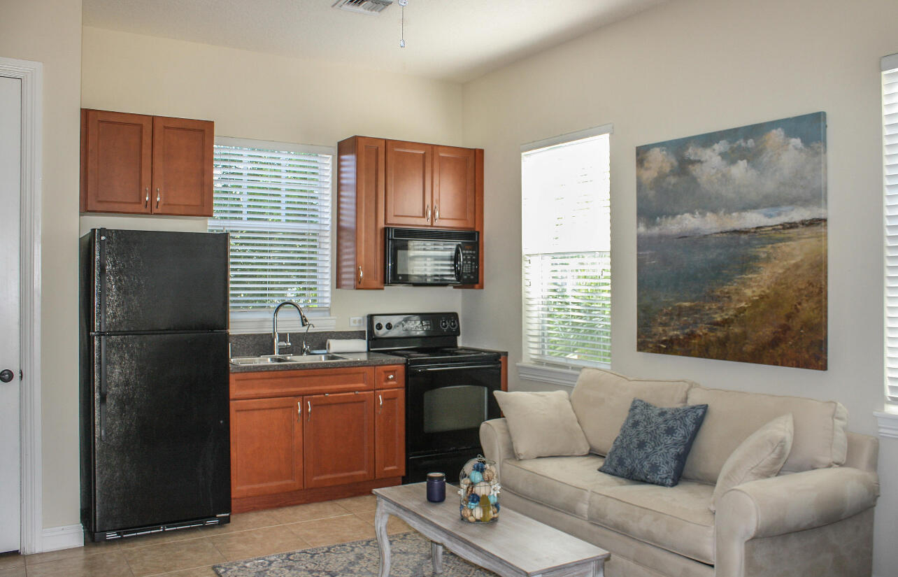 113 Inkberry Drive Jupiter, FL 33458 - Photo 3 of 4 a living room with furniture and a flat screen tv