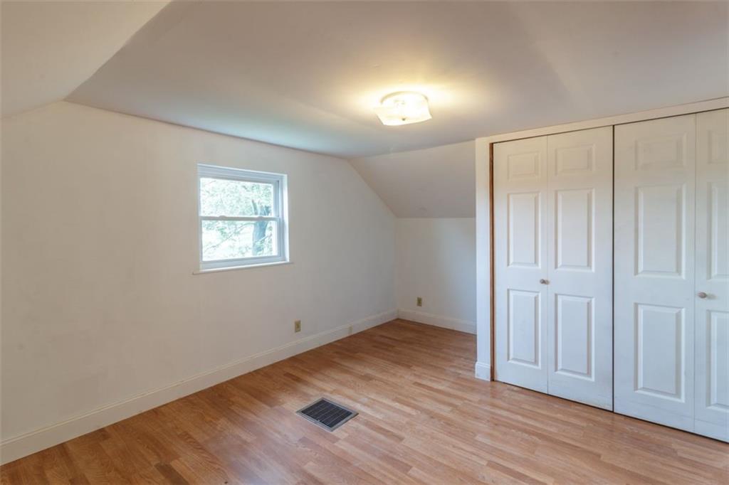 803 Cliff Mine Road Imperial, PA 15126 - Photo 16 of 24 an empty room with wooden floor and windows