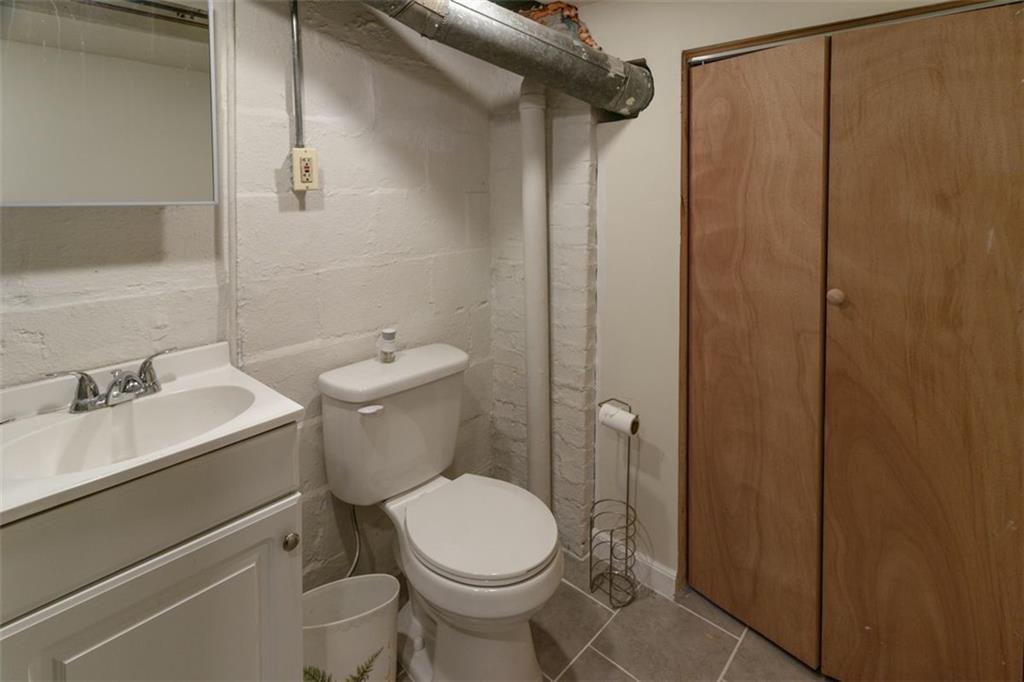 803 Cliff Mine Road Imperial, PA 15126 - Photo 17 of 24 a white toilet sitting next to a bathroom sink