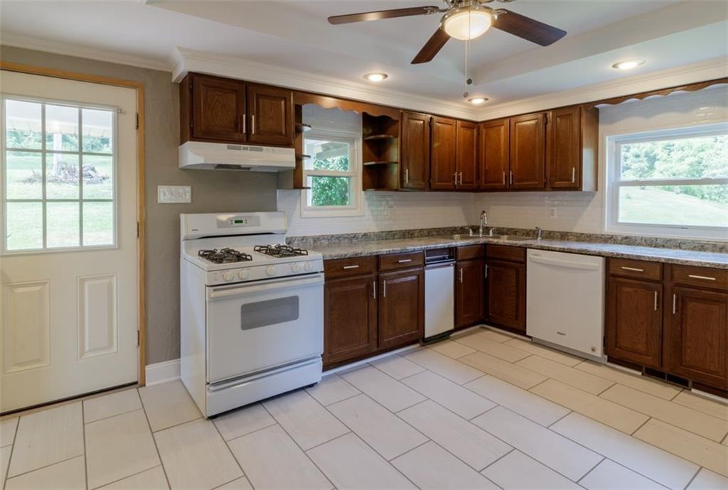 803 Cliff Mine Road Imperial, PA 15126 - Photo 7 of 24 a kitchen with stainless steel appliances granite countertop a stove sink and cabinets