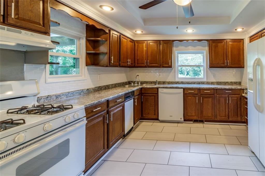 803 Cliff Mine Road Imperial, PA 15126 - Photo 8 of 24 a kitchen with stainless steel appliances granite countertop a stove sink and cabinets