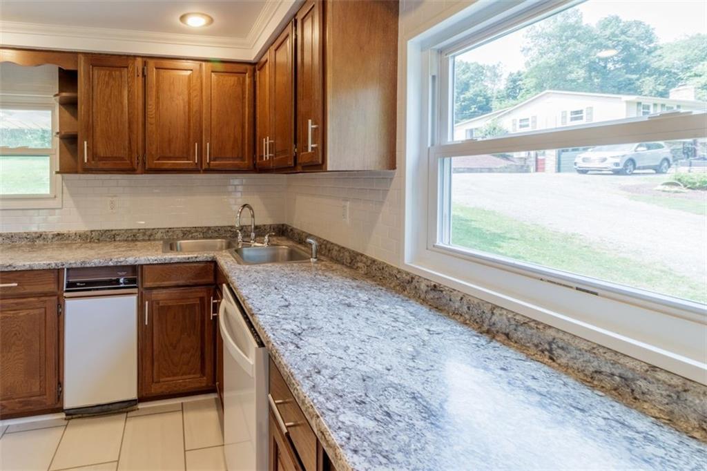 803 Cliff Mine Road Imperial, PA 15126 - Photo 9 of 24 a kitchen with granite countertop a sink and a window