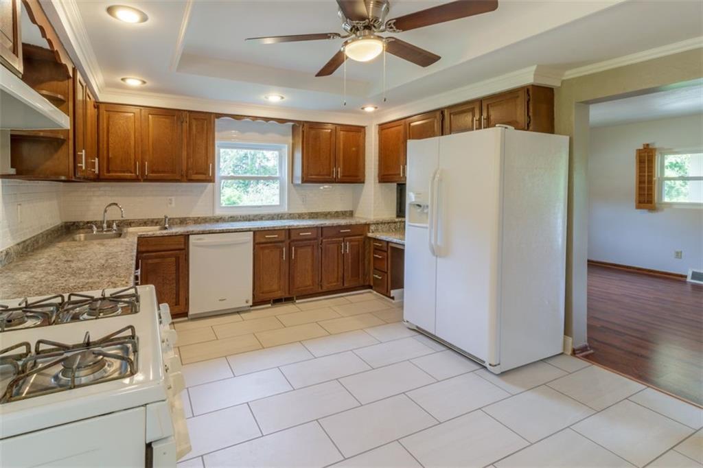 803 Cliff Mine Road Imperial, PA 15126 - Photo 10 of 24 a kitchen with stainless steel appliances granite countertop a refrigerator and a stove top oven