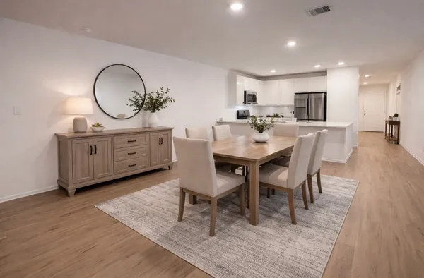 a view of a dining room with furniture and wooden floor