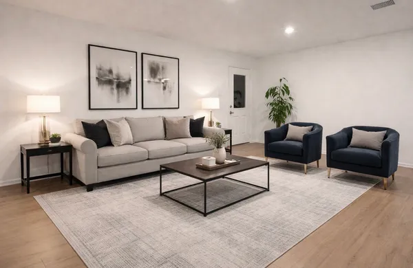 a living room with furniture and a lamp