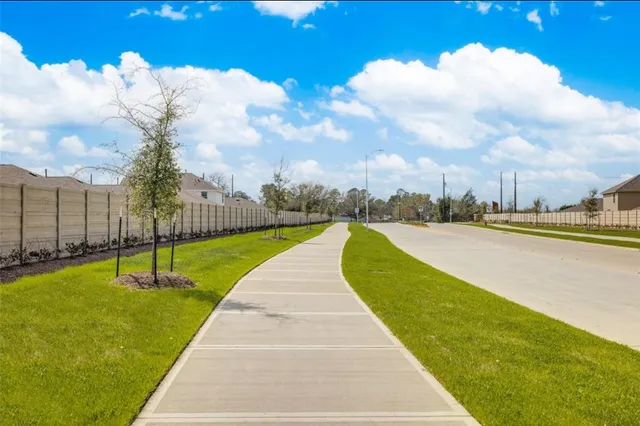 a view of swimming pool that has lawn chairs with plants